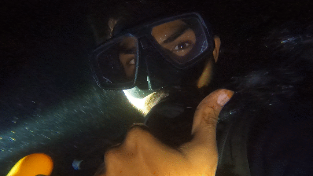 A Scuba diver, diving in the night