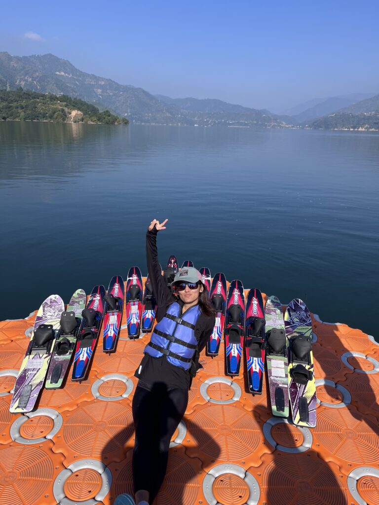 A lady capturing photos with water skis.
